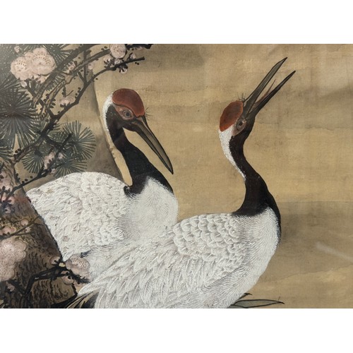 1907 - A large 20th century Chinese painting depicting two black-necked cranes in a landscape scene, with a... 