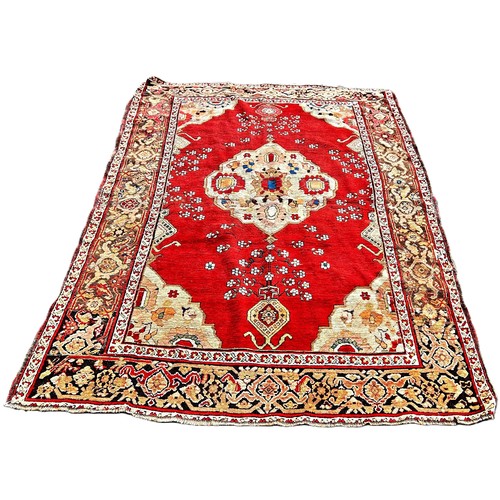 6007 - A Middle Eastern Karabagh rug with a central medallion on floral red ground, 208cm x 146cm approxima... 