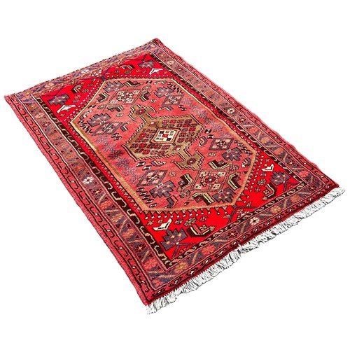 6015 - A Persian Hamadan design rug with a central medallion on a pink field, 100cm x 150cm