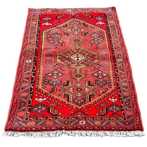 6015 - A Persian Hamadan design rug with a central medallion on a pink field, 100cm x 150cm