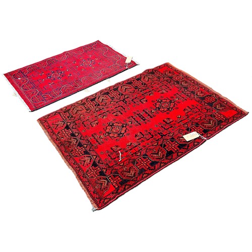 6026 - Two Afghan type  carpets both with red fields, 120cm x 80cm and 155cm x 105cm