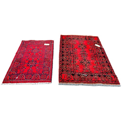 6026 - Two Afghan type  carpets both with red fields, 120cm x 80cm and 155cm x 105cm