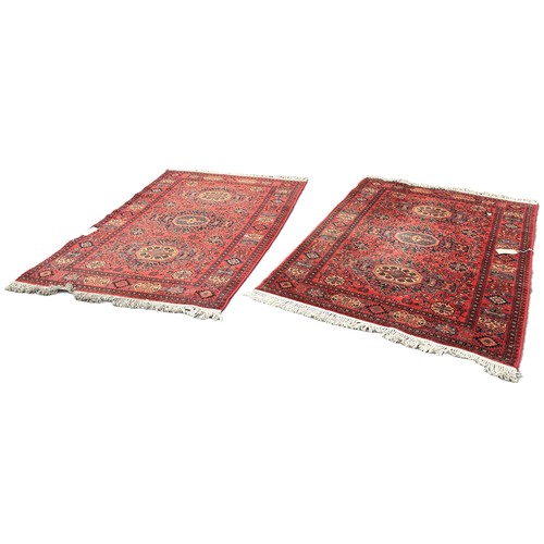 6035 - A pair of Belgian machine made Persian style carpets with an all over floral and geometric design, 2... 