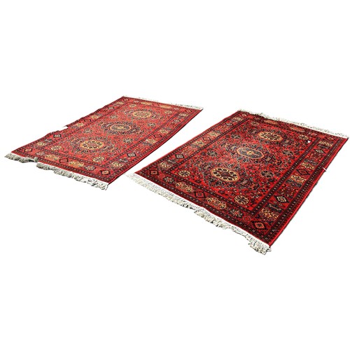 6035 - A pair of Belgian machine made Persian style carpets with an all over floral and geometric design, 2... 