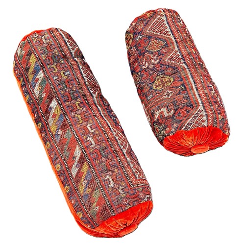 6041 - Two bolster cushions upholstered in old Persian carpet with velvet ends.