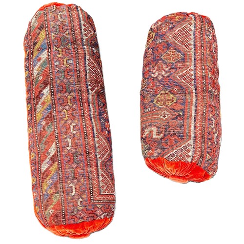 6041 - Two bolster cushions upholstered in old Persian carpet with velvet ends.