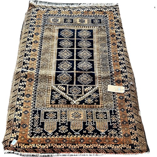 1610 - A small worn prayer mat with a geometric central panel, 140cm x 90cm approximately