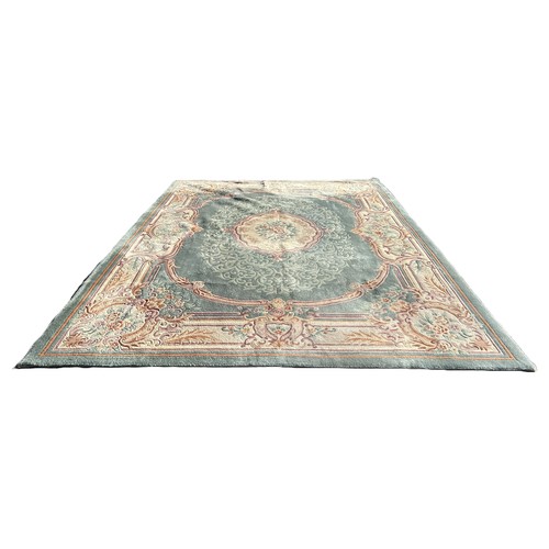 1621 - A large Chinese wool carpet with a central medallion on a green ground and floral borders, 275cm x 3... 