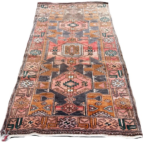 1656 - An old Middle Eastern carpet  with an all over geometric pattern, 225cm x 110cm