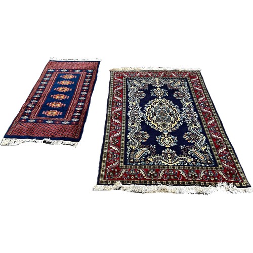 1651 - A small Bokhara rug and a small Persian designed rug, 130cm x 65cm and 150cm x 105cm respectively