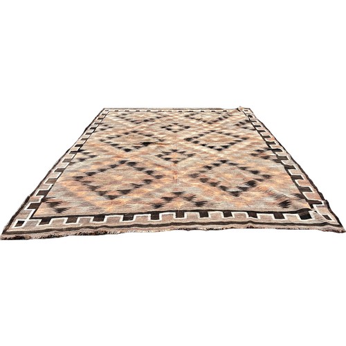 1645 - A large faded Kilim with a brown zig-zag geometric pattern 335cm x 280cm