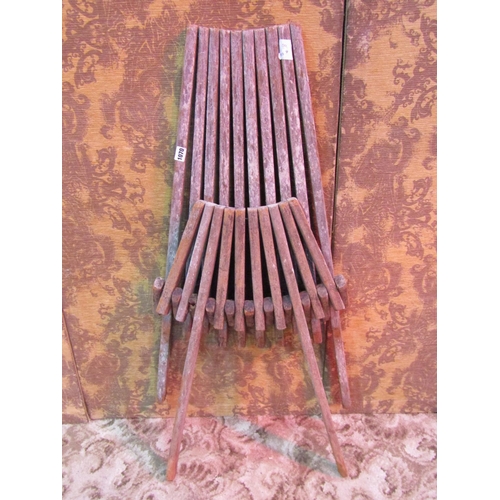 1070 - A weathered folding hardwood chair with tapered slatted framework (af)