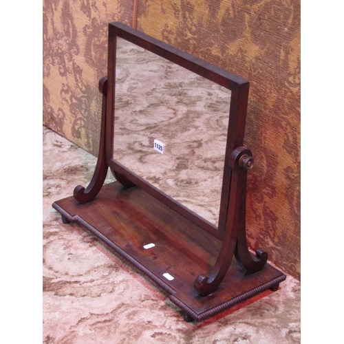 1125 - An early 19th century mahogany toilet mirror with rectangular plate, raised on scrolled supports and... 