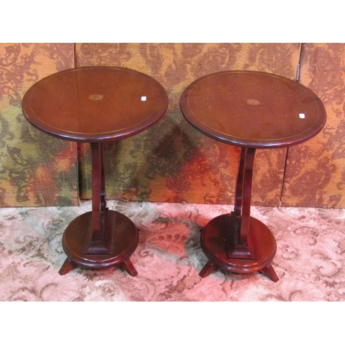 1167 - A pair of small reproduction Regency style occasional tables of oval form raised on lyre shaped supp... 