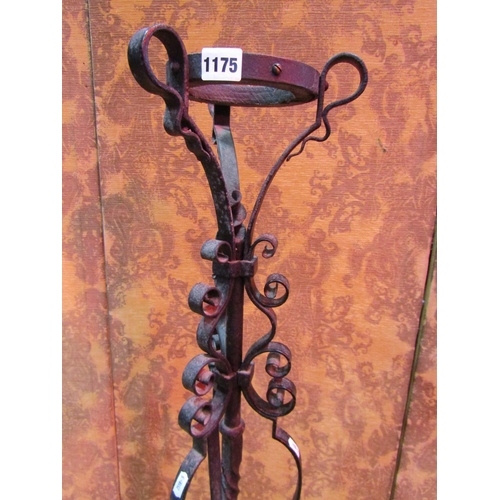 1175 - A heavy gauge wrought iron lampstand with open scrolled detail and supports, 154 cm high