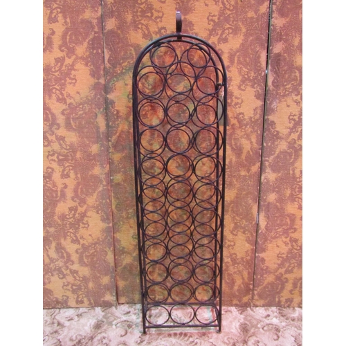 1217 - A floorstanding ironwork wine rack of arched form to contain 32 bottles