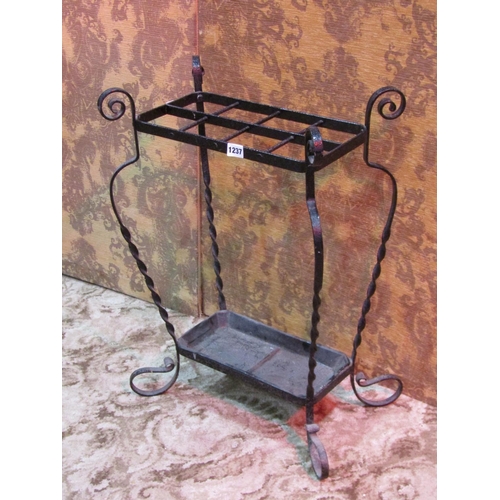 1237 - An iron work umbrella/stick stand with eight divisions on scrolled supports