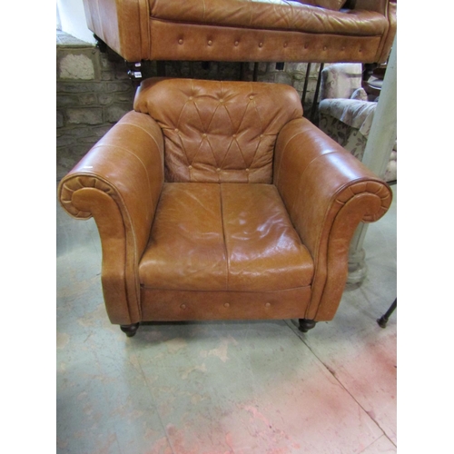 1298 - A good quality contemporary but traditional style tan leather sofa with buttoned back and rolled arm... 