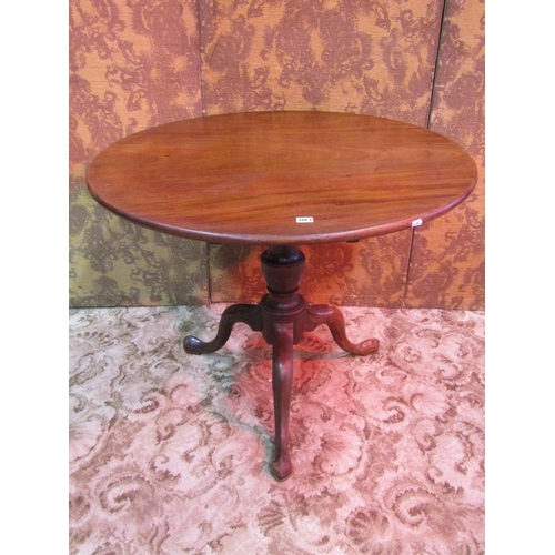 1302 - A Georgian mahogany snap top table of circular form, the one piece top 90cm approx diameter, raised ... 