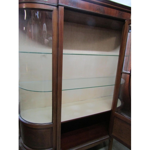 1303 - An inlaid Edwardian mahogany display cabinet enclosed by a central partially glazed split moulded pa... 