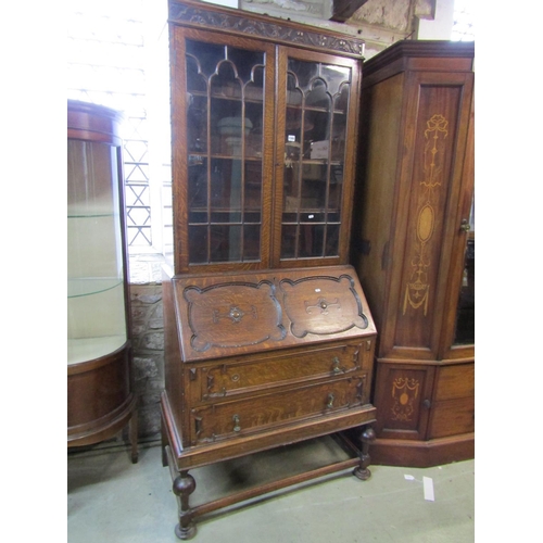 1305 - A 1920s oak bureau bookcase with Jacobean style mouldings, 211cm high x 101cm x 52cm