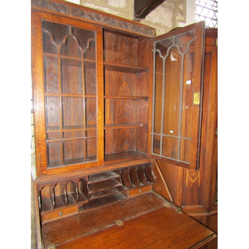 1305 - A 1920s oak bureau bookcase with Jacobean style mouldings, 211cm high x 101cm x 52cm