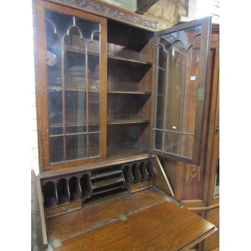 1305 - A 1920s oak bureau bookcase with Jacobean style mouldings, 211cm high x 101cm x 52cm