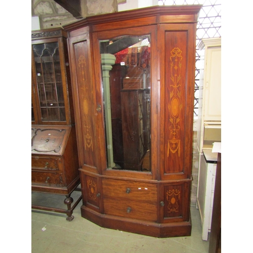 1306 - A good quality inlaid Edwardian breakfront wardrobe enclosed by a bevelled edge mirror panelled door... 