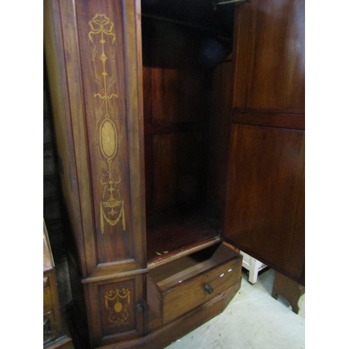 1306 - A good quality inlaid Edwardian breakfront wardrobe enclosed by a bevelled edge mirror panelled door... 