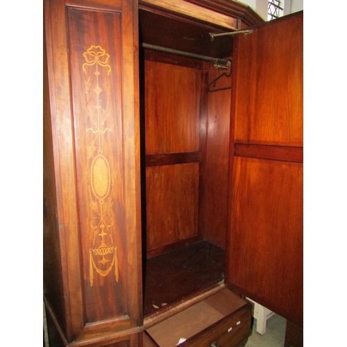 1306 - A good quality inlaid Edwardian breakfront wardrobe enclosed by a bevelled edge mirror panelled door... 