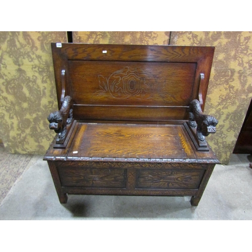 1320 - A carved oak monks bench with hinged box seat and carved lions supporting a sliding top, 72cm high x... 