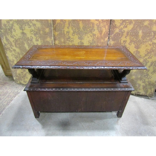 1320 - A carved oak monks bench with hinged box seat and carved lions supporting a sliding top, 72cm high x... 