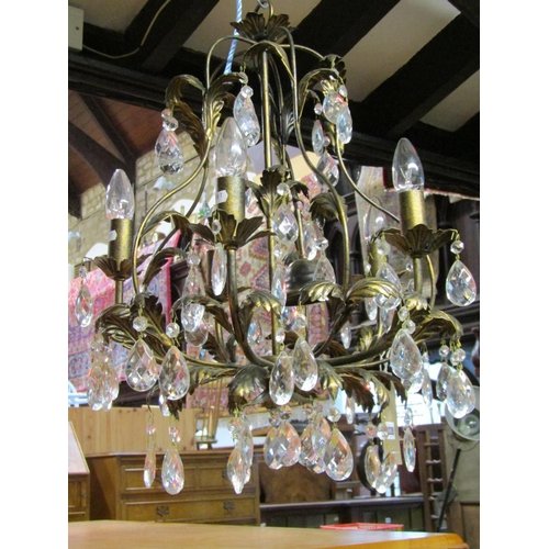 1328 - A pair of decorative five branch chandeliers with prism tear shaped droplets and leaf detail, approx... 