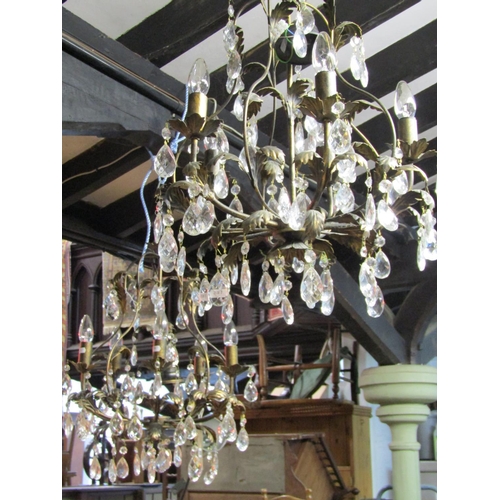 1328 - A pair of decorative five branch chandeliers with prism tear shaped droplets and leaf detail, approx... 