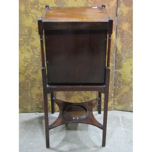 1342 - A mahogany bedside cabinet in the Georgian style enclosed by a panelled door on square cut supports,... 