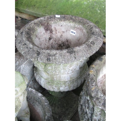 1014 - A collection of weathered cast composition stone garden urns and planers of varying sizes and design... 