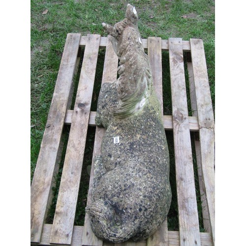 1028 - A weathered cast composition stone garden ornament in the form of a recumbent horse (af), 56 cm high... 