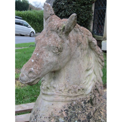 1028 - A weathered cast composition stone garden ornament in the form of a recumbent horse (af), 56 cm high... 