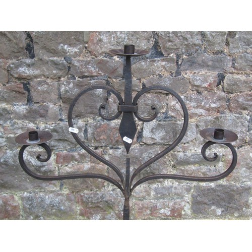 1032 - An ironwork floorstanding three branch candelabra with open scroll detail, 120 cm high, together wit... 