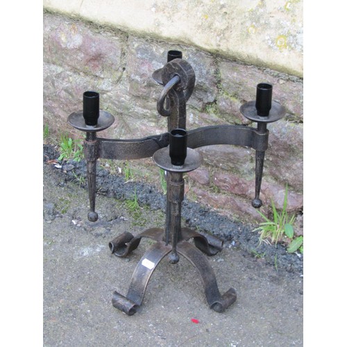 1032 - An ironwork floorstanding three branch candelabra with open scroll detail, 120 cm high, together wit... 