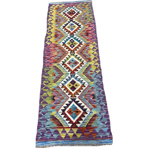 1614 - A Chobi kilim runner with a central row of interlocking stepped medallions with hints of purple, 198... 