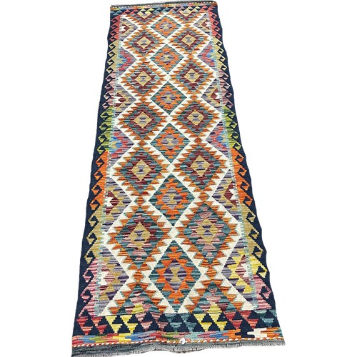 1608 - A Chobi Kilim runner with alternating rows of multicoloured diamonds 248cm x 81cm Approximately