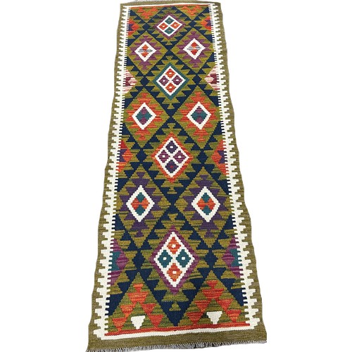 1643 - A Maimama kilim runner with alternating rows of diamonds on a dark field, 202cm x 63cm approximately