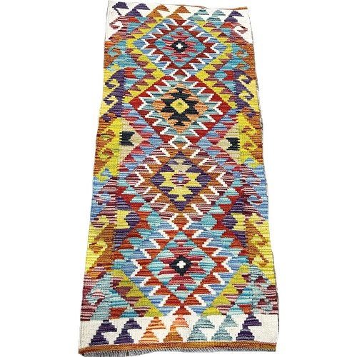 1617 - A Chobi kilim runner with a repeating all over diamond pattern, 142cm x 63cm