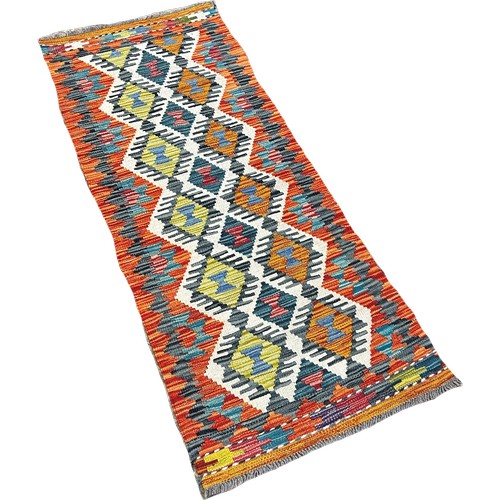 1623 - A Chobi Kilim runner with a central panel of stepped diamonds, 149cm x 59cm