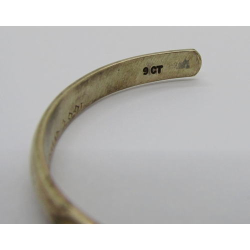 334 - 9ct bangle, London 1970, 15.9g (slightly misshapen) and a further 9ct torque bangle set with green g... 