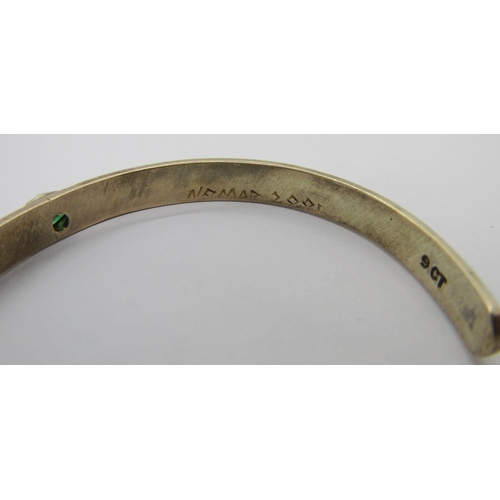 334 - 9ct bangle, London 1970, 15.9g (slightly misshapen) and a further 9ct torque bangle set with green g... 