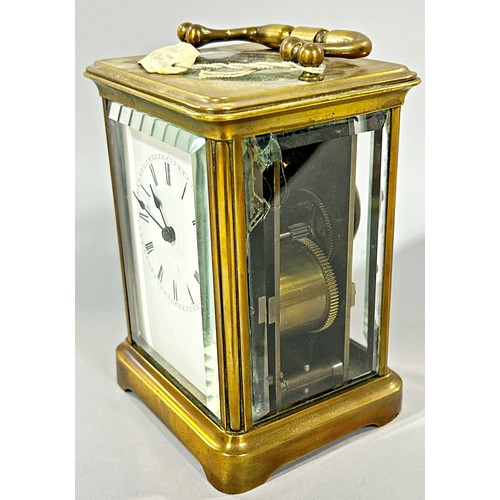 438 - A small brass cased carriage clock with white enamelled dial, 13cm high.