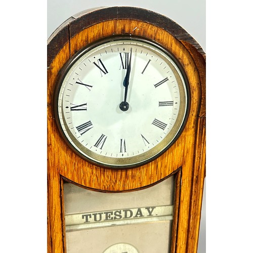 440 - A late Victorian / Edwardian oak cased table clock/calendar, 3.5” dial, 34cm high.