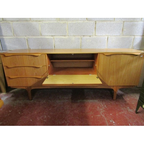 1520 - A mid 20th century ‘S Form’ teak sideboard, fitted with an arrangement of drawers and cupboards, 78c... 